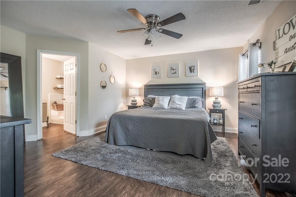 5901 Creft Circle Indian Trail, NC 28079 - Photo 13 of 26 a bedroom with a bed and a table with wooden floor