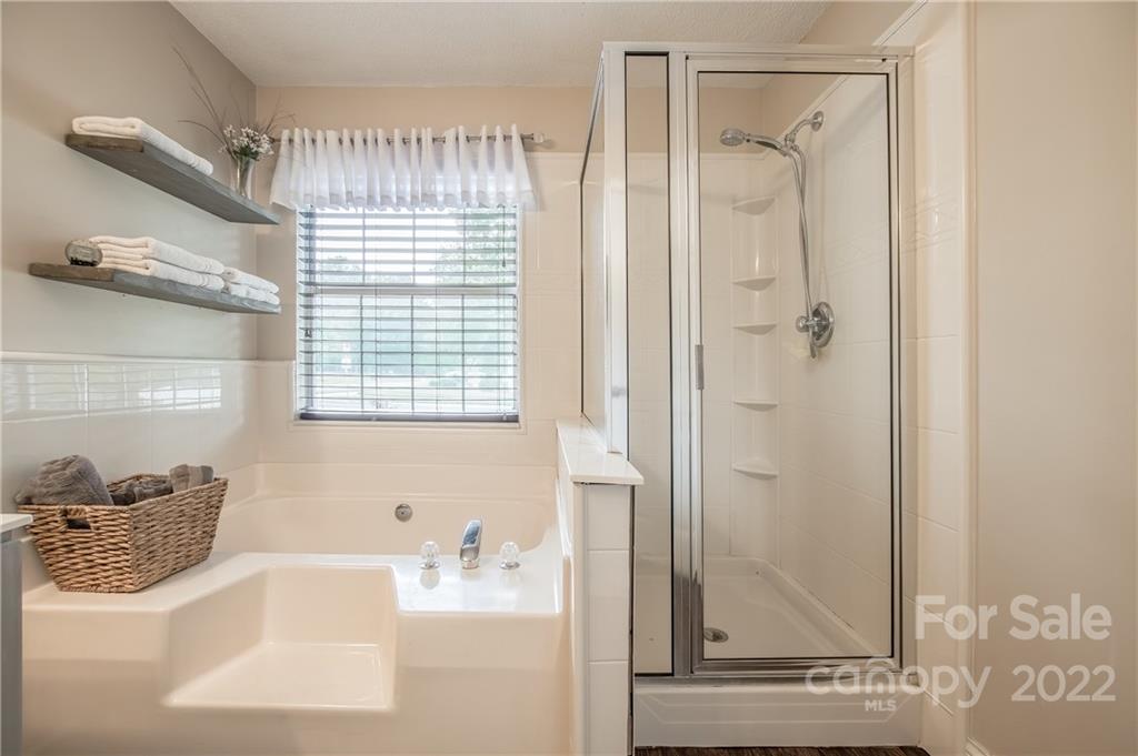 5901 Creft Circle Indian Trail, NC 28079 - Photo 15 of 26 a bathroom with a bathtub and a sink