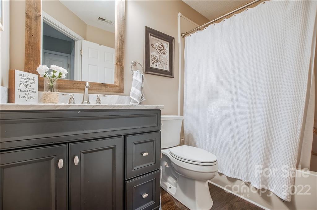 5901 Creft Circle Indian Trail, NC 28079 - Photo 20 of 26 a bathroom with a sink a toilet and a mirror