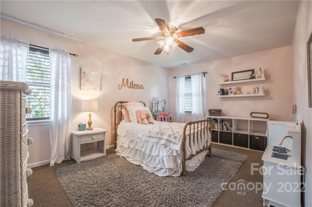 5901 Creft Circle Indian Trail, NC 28079 - Photo 21 of 26 a bedroom with a bed and a chandelier