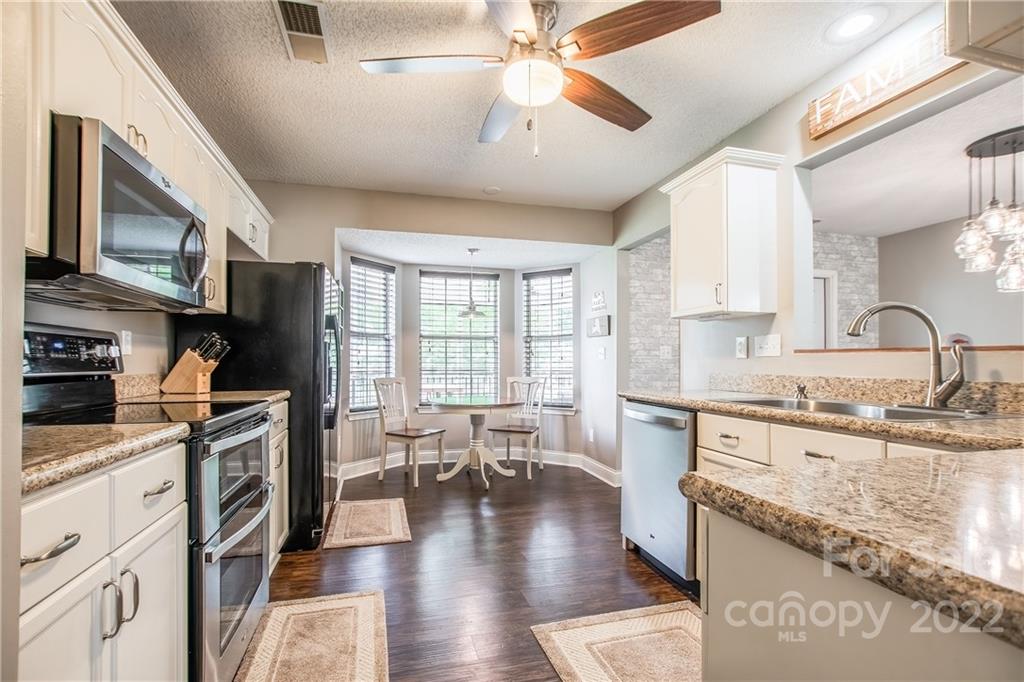 5901 Creft Circle Indian Trail, NC 28079 - Photo 9 of 26 a kitchen with a stove a sink and a refrigerator