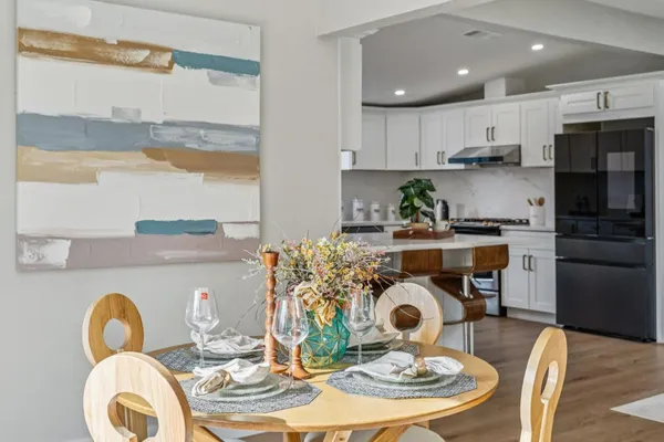a kitchen with dining table and a large window