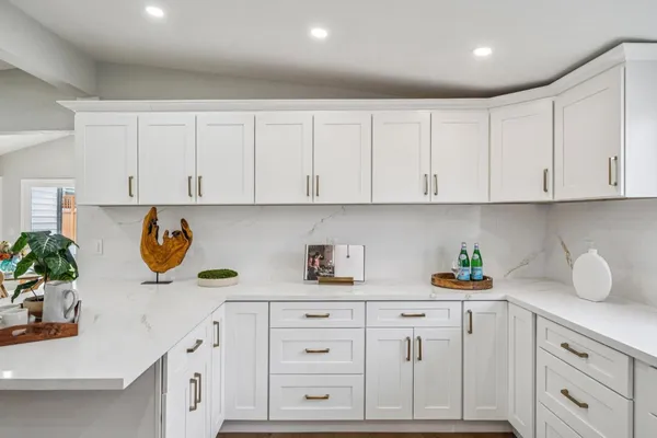 a kitchen with white cabinets and a stainless steel appliances