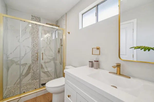a bathroom with a sink toilet and shower