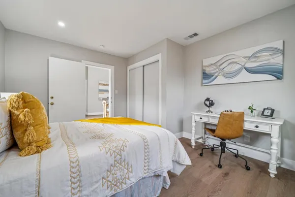 a bedroom with a bed and chair