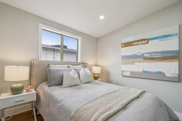 a bedroom with a bed and a large window