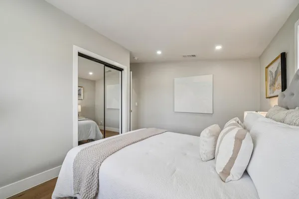 a bedroom with a bed and a night stand
