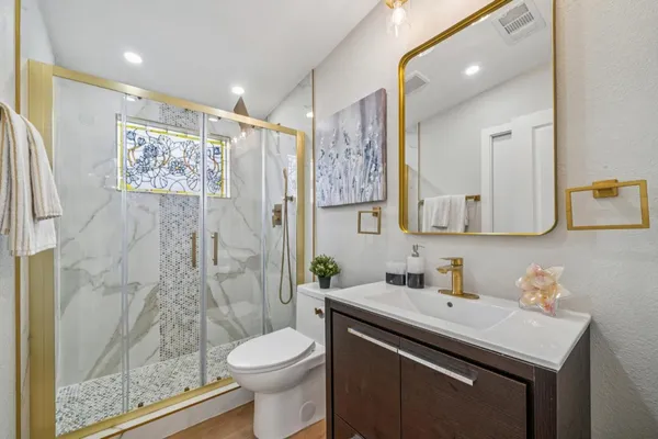 a bathroom with a sink toilet and shower
