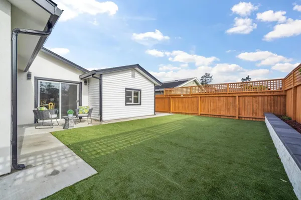 a view of a backyard with plants and a garden