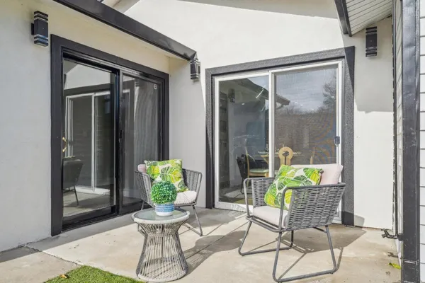a view of a porch with a table and chairs