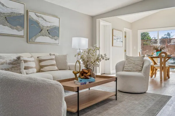 a living room with furniture and a potted plant