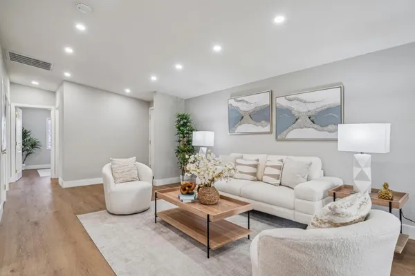 a living room with furniture and a lamp