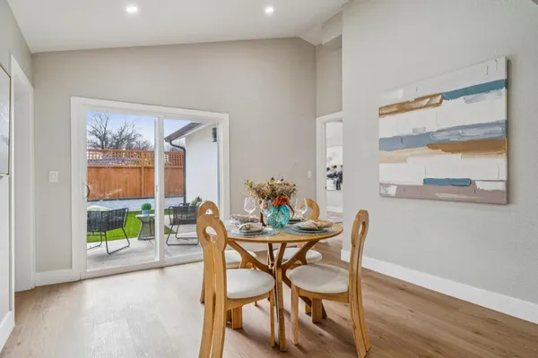 a dining room with furniture and a wooden floor