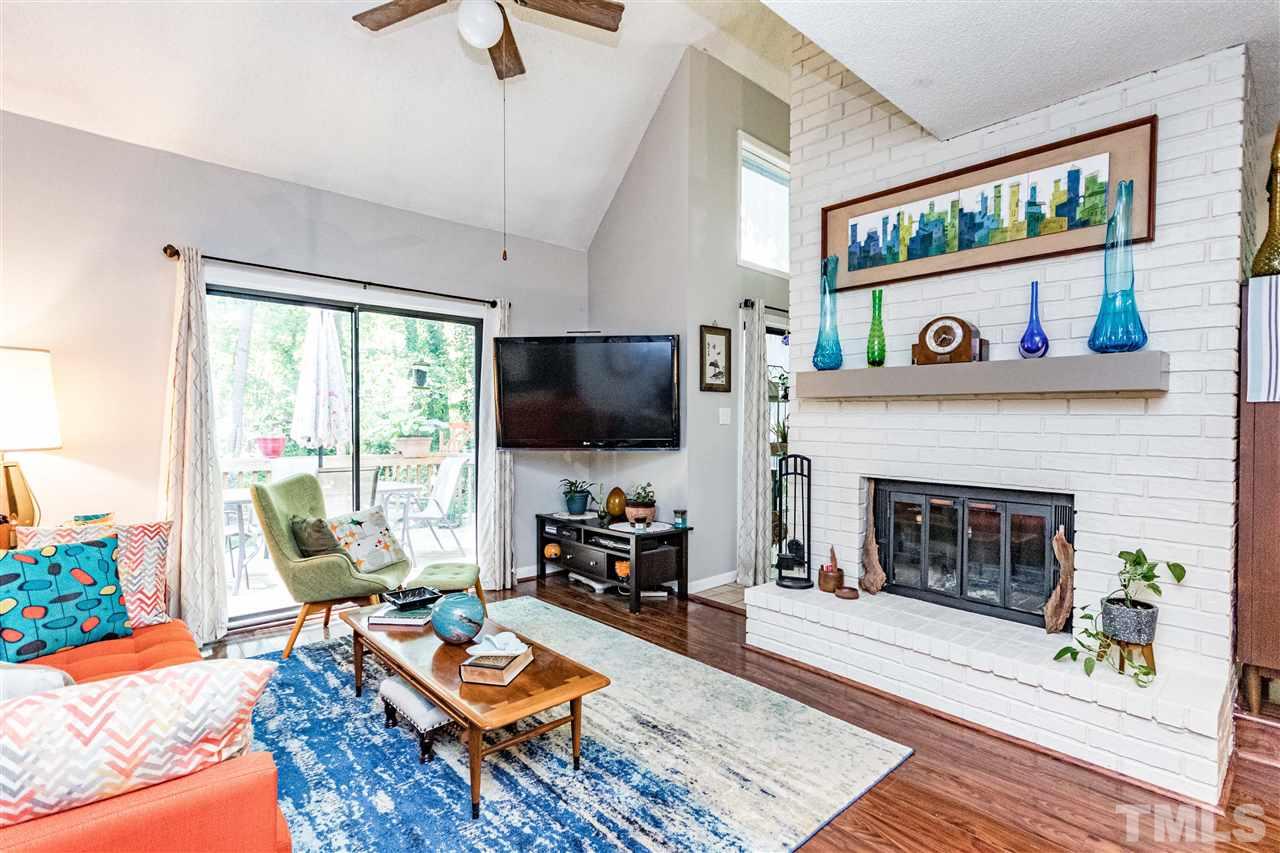 4339 Southwind Drive Raleigh, NC 27613 - Photo 12 of 24 a living room with furniture a flat screen tv and a fireplace