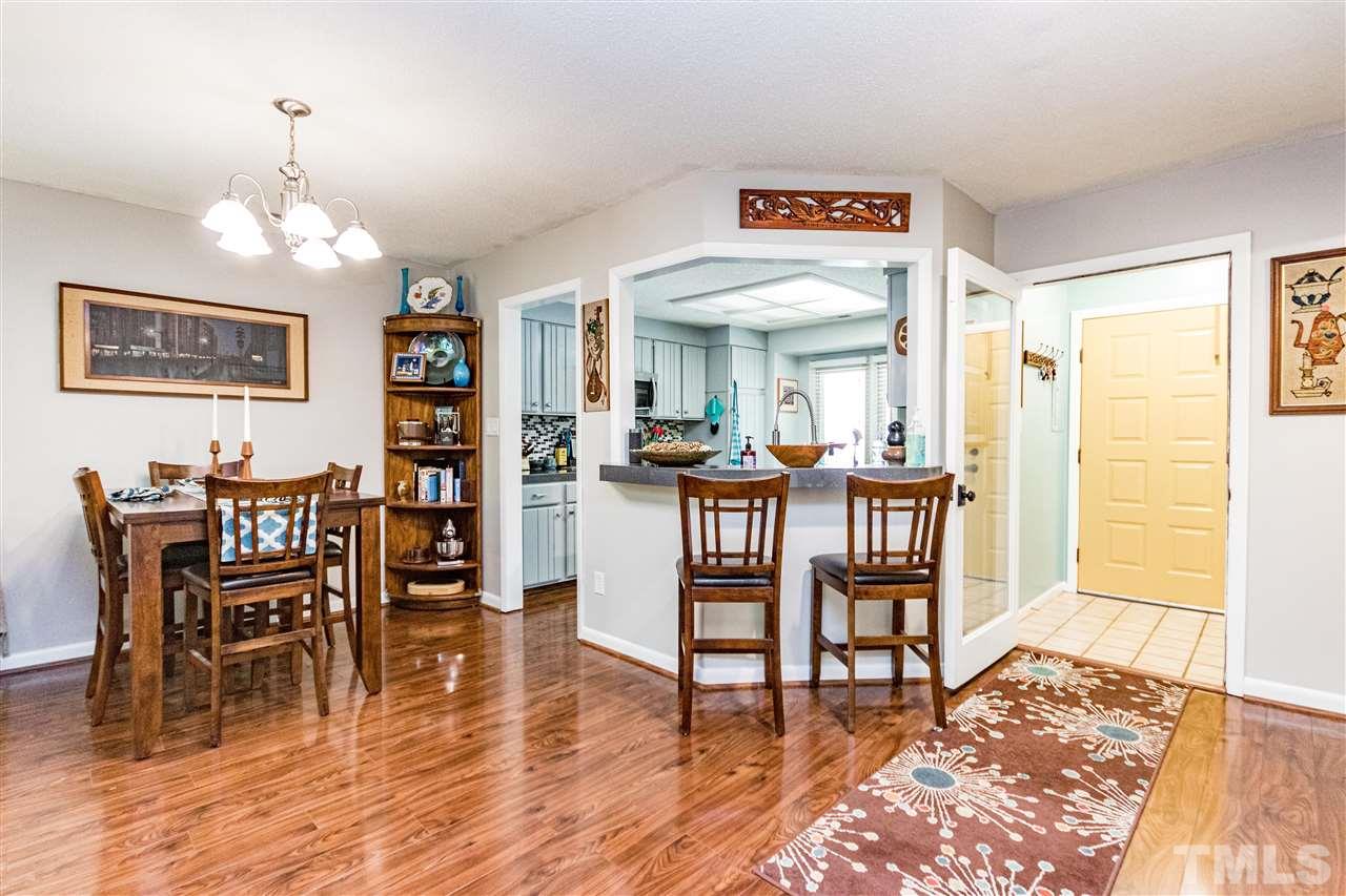4339 Southwind Drive Raleigh, NC 27613 - Photo 3 of 24 a view of a dining room with furniture and wooden floor