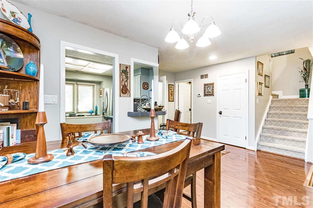 4339 Southwind Drive Raleigh, NC 27613 - Photo 4 of 24 a dining room with wooden floor and chandelier