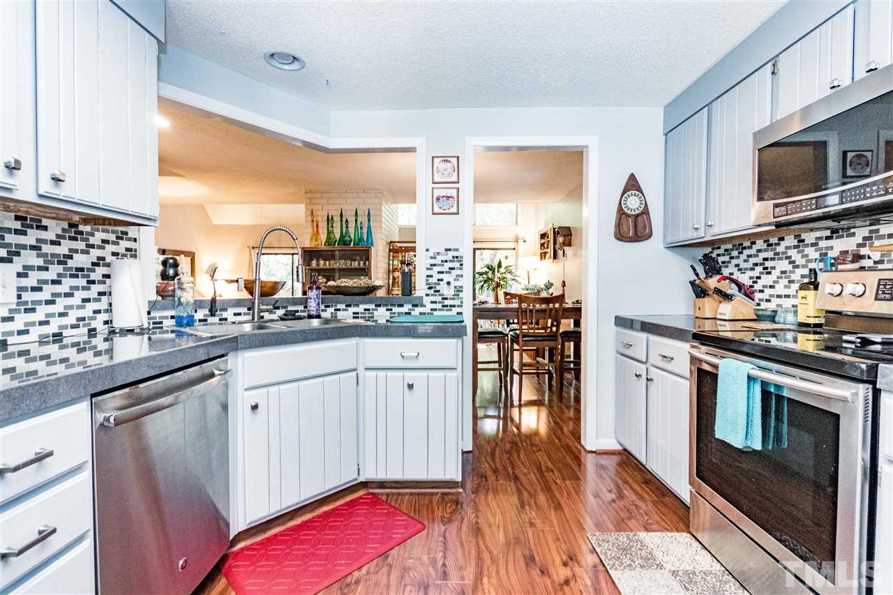 4339 Southwind Drive Raleigh, NC 27613 - Photo 7 of 24 a kitchen with stainless steel appliances granite countertop a stove and a sink