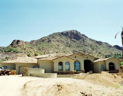 5112 East Rockridge Road, Unit VIEWS Phoenix, AZ 85018 - Photo 1 of 1 a front view of a house with a yard covered in snow