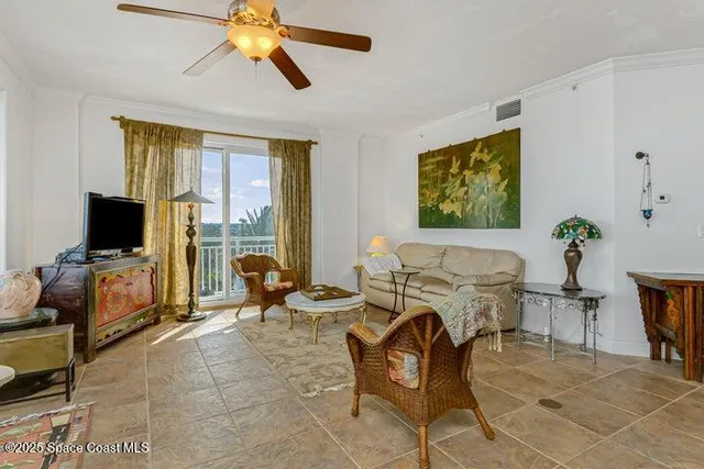 a living room with furniture a flat screen tv and a window