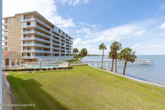 a swimming pool with outdoor seating and yard