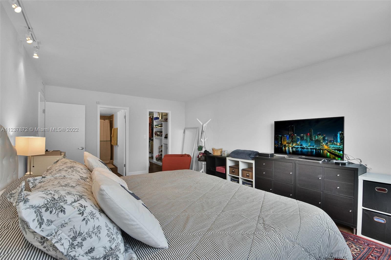 South Central Beach Hollywood, FL 33019 - Photo 14 of 30 a bedroom with a bed and a flat screen tv