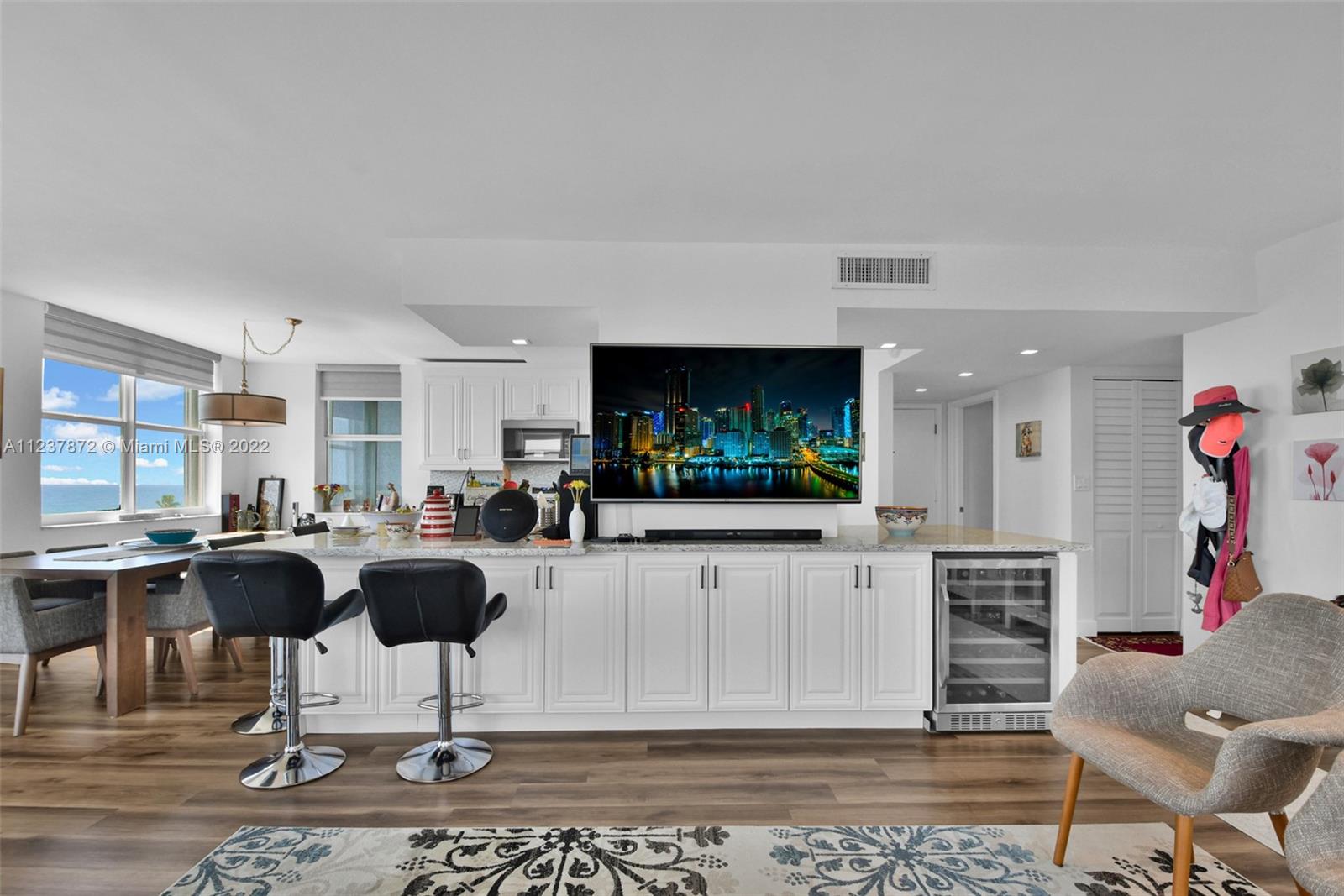 South Central Beach Hollywood, FL 33019 - Photo 19 of 30 a living room with furniture a rug and a flat screen tv