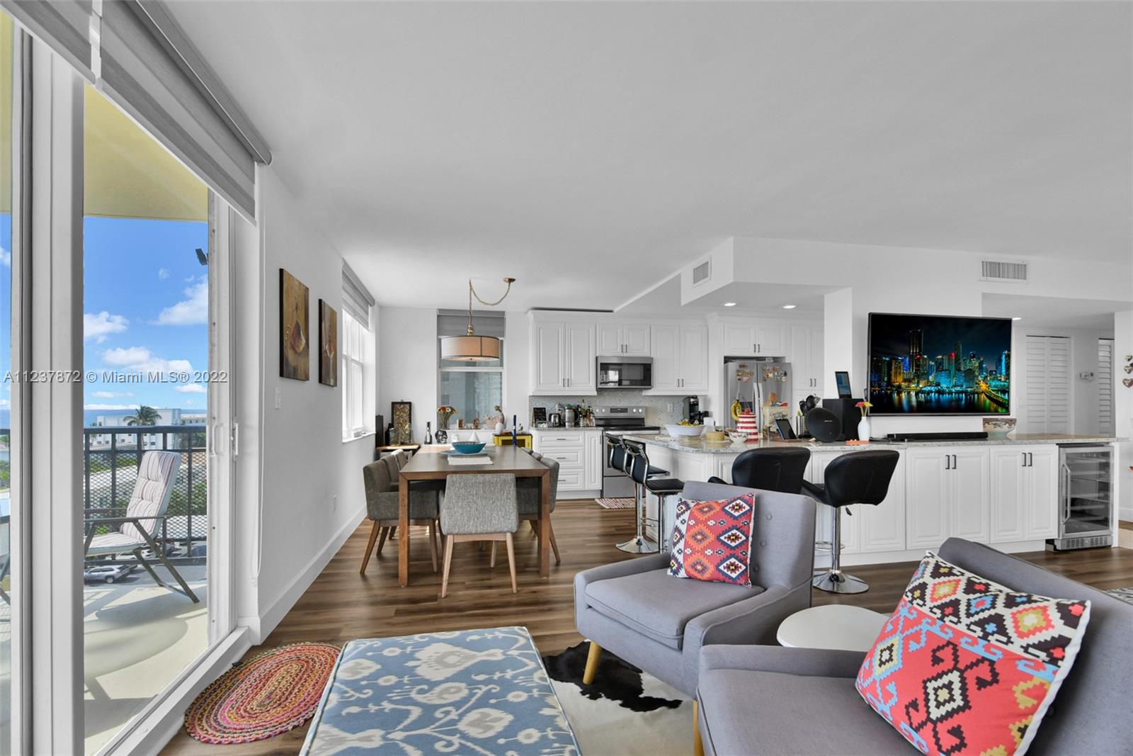 South Central Beach Hollywood, FL 33019 - Photo 21 of 30 a living room with furniture a rug and a flat screen tv