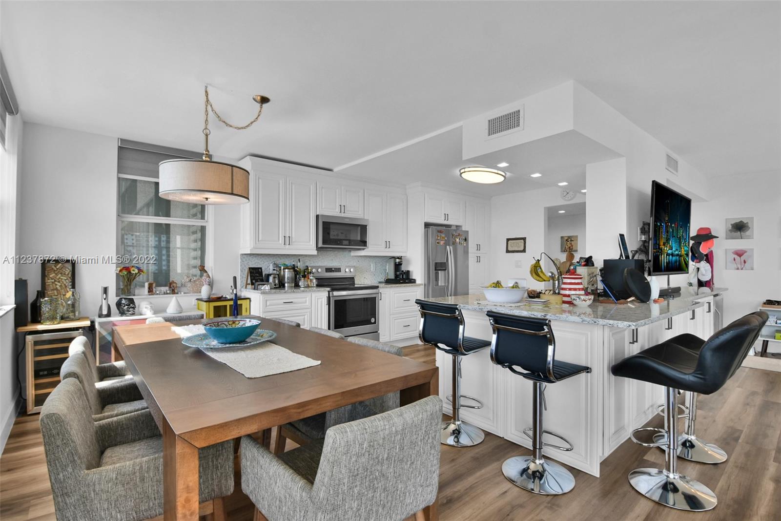 South Central Beach Hollywood, FL 33019 - Photo 22 of 30 a view of kitchen with dining table and chairs