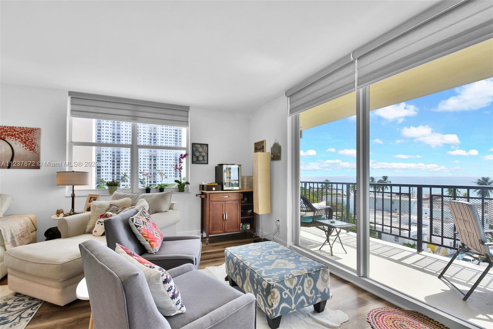 South Central Beach Hollywood, FL 33019 - Photo 5 of 30 a living room with furniture and a floor to ceiling window