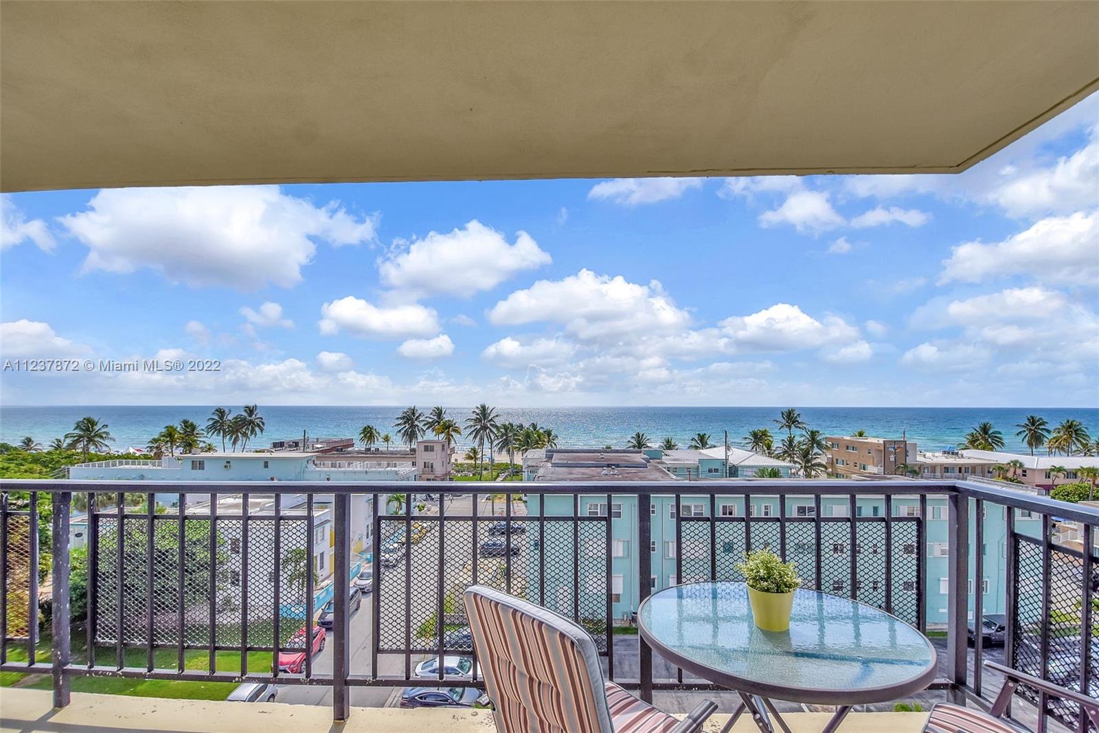 South Central Beach Hollywood, FL 33019 - Photo 6 of 30 a view of a balcony with wooden floor and city view