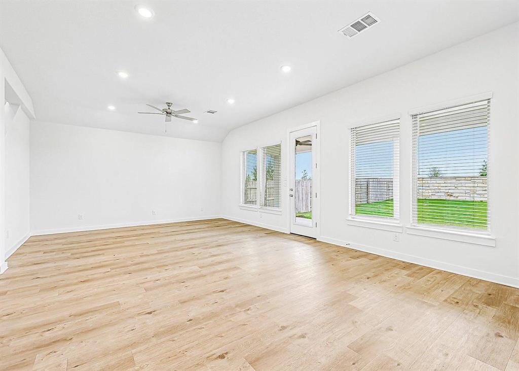 408 Brandywine Road Hutto, TX 78634 - Photo 10 of 13 Gleaming hardwood floors and abundant windows define this versatile living space.