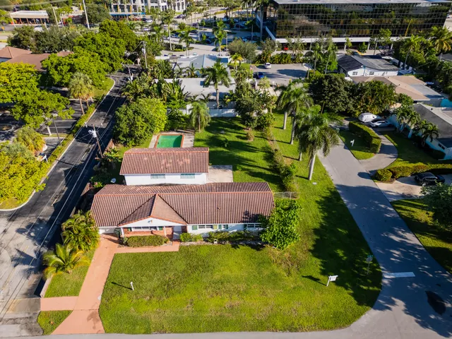 an aerial view of residential houses with outdoor space and street view
