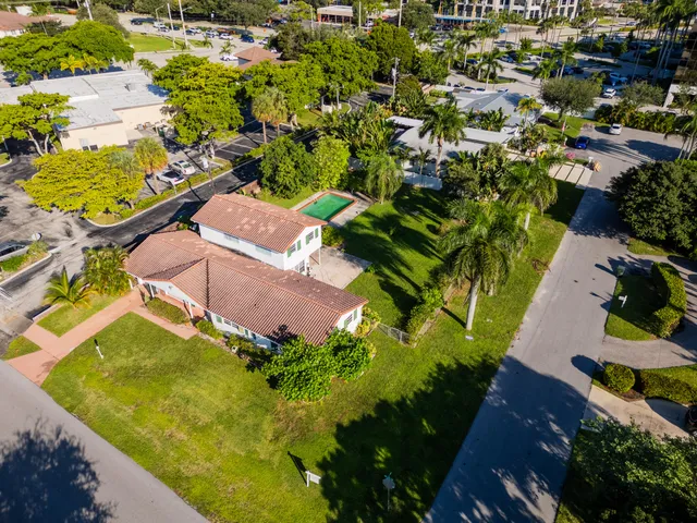 an aerial view of residential houses with swimming pool