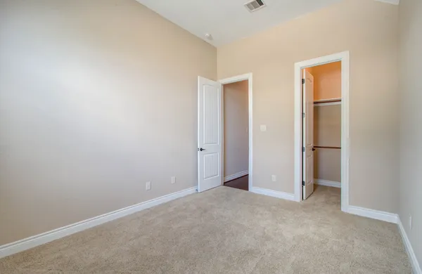 an empty room with closet area