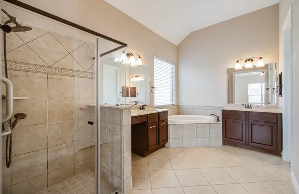 a large bathroom with a mirror a double vanity sink and mirror