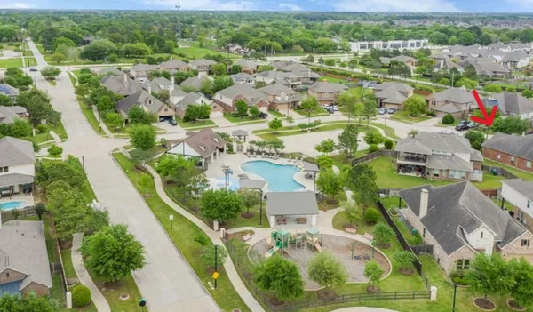 an aerial view of residential houses with outdoor space and street view