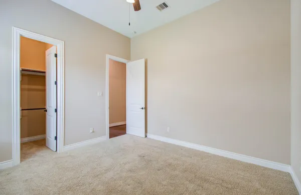 an empty room with closet area