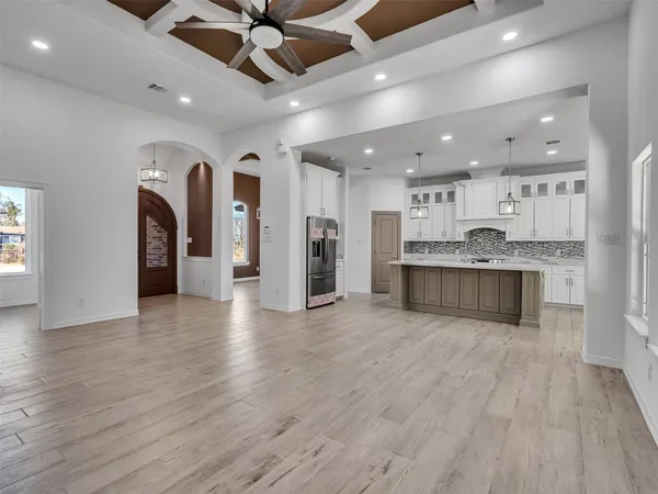 a view of a kitchen with a sink and a refrigerator
