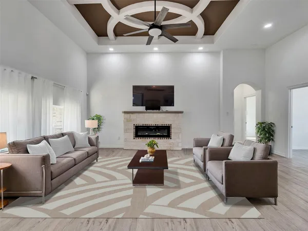 a living room with furniture a fireplace and a flat screen tv