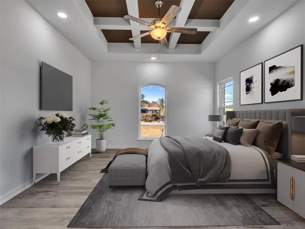 a spacious bedroom with a bed couches and flat screen tv