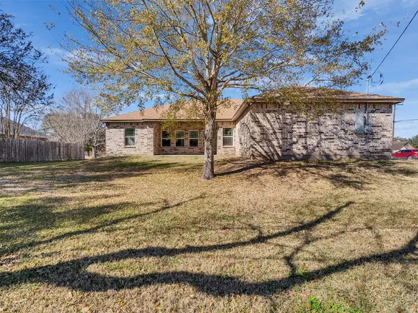a view of a yard with wooden fence
