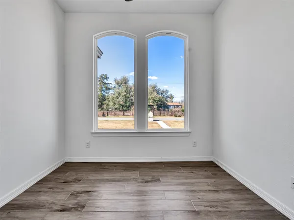 a view of a room has window and wooden floor