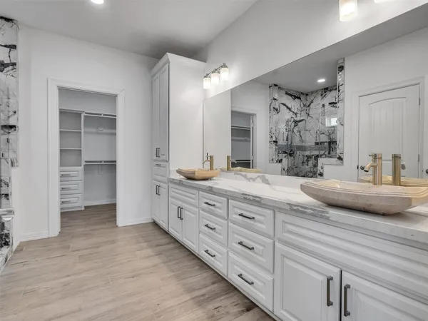a spacious bathroom with double sink and a large mirror