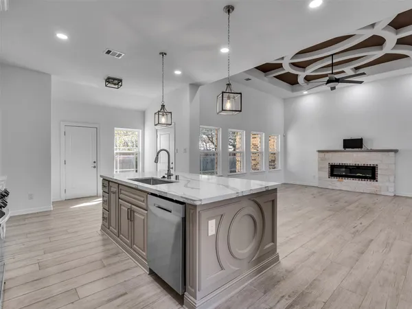 a kitchen with granite countertop a sink and a stove top oven