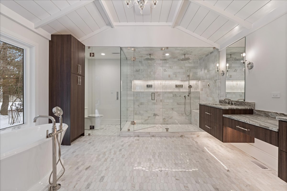 819 Wagner Road Glenview, IL 60025 - Photo 12 of 20 a spacious bathroom with a granite countertop sink a toilet a mirror and shower