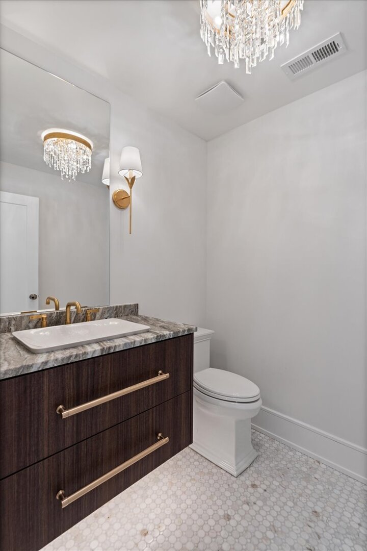 819 Wagner Road Glenview, IL 60025 - Photo 16 of 20 a bathroom with a granite countertop toilet and a sink