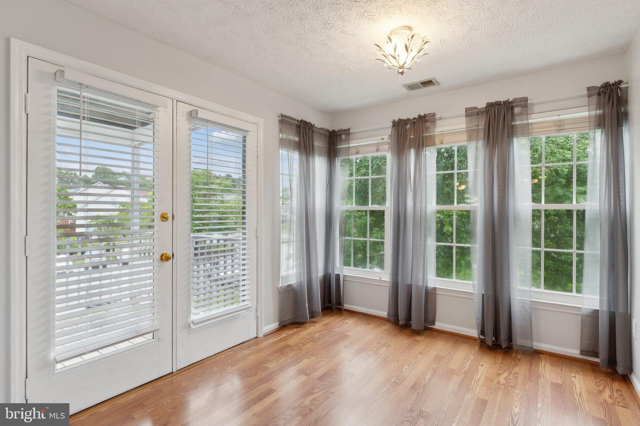 815 Deering Road, Unit 7H Pasadena, MD 21122 - Photo 11 of 24 a view of empty room with wooden floor and fan