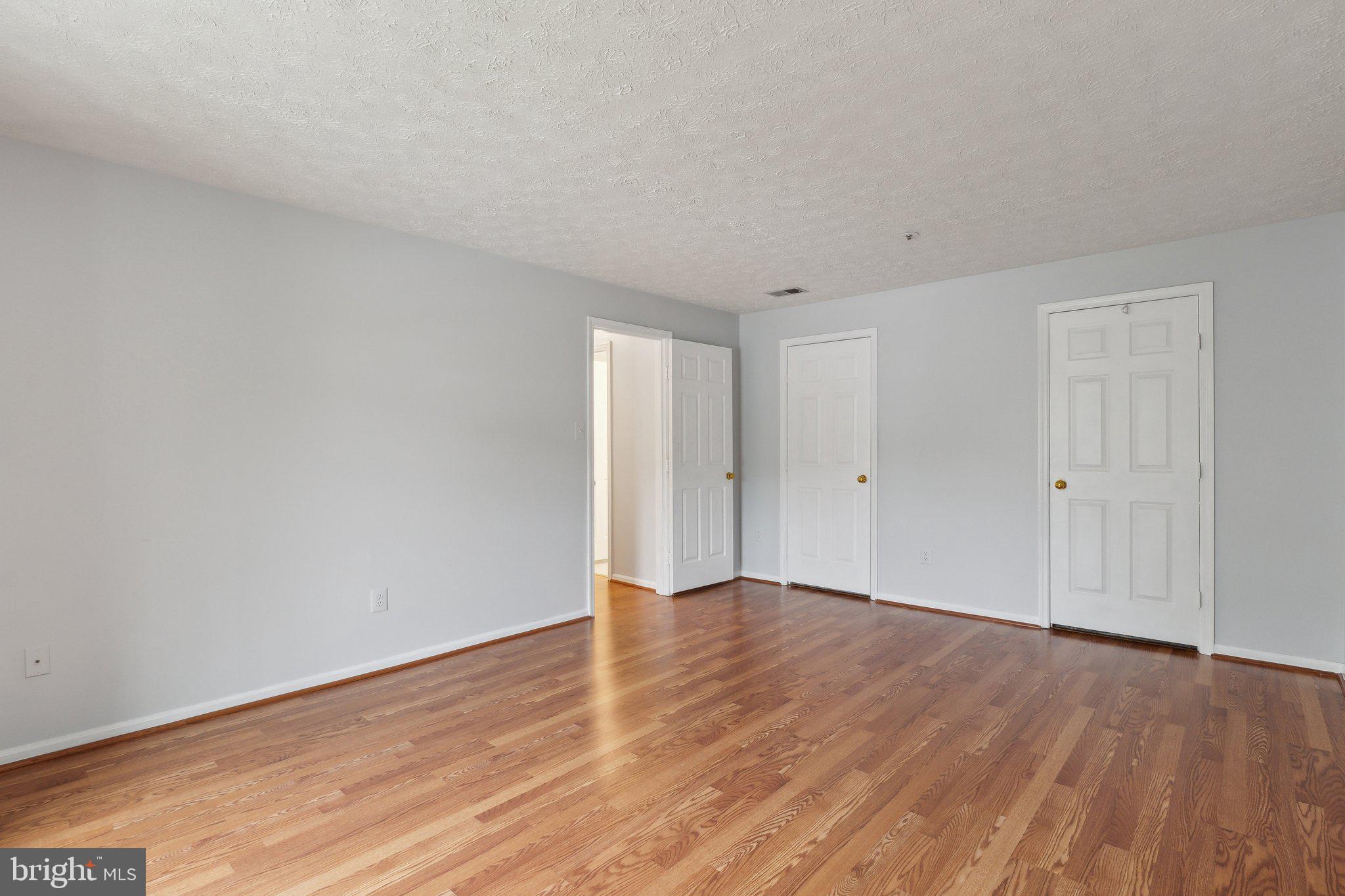 815 Deering Road, Unit 7H Pasadena, MD 21122 - Photo 16 of 24 a view of an empty room with wooden floor