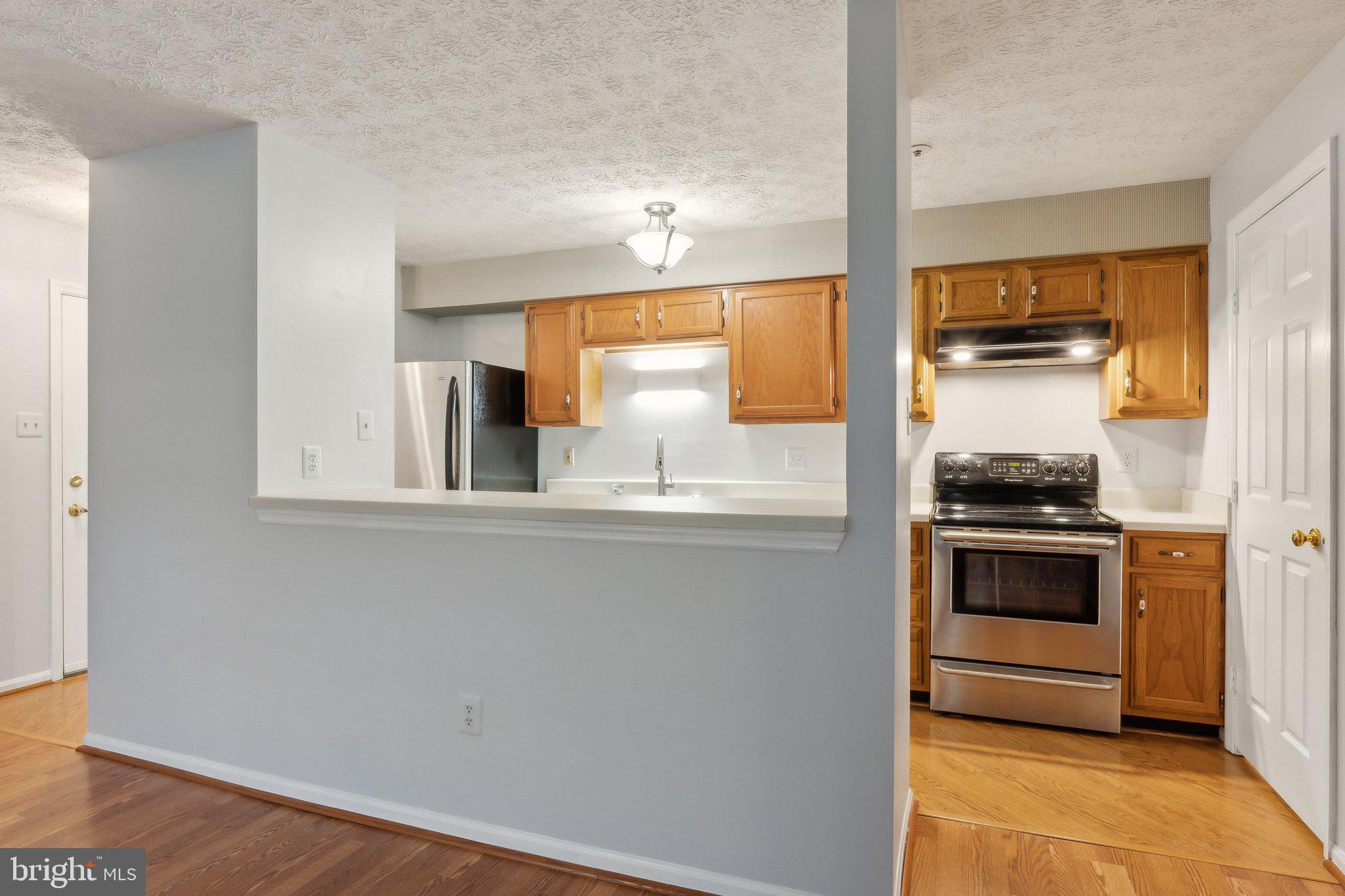 815 Deering Road, Unit 7H Pasadena, MD 21122 - Photo 4 of 24 a kitchen with stainless steel appliances granite countertop a stove and a refrigerator