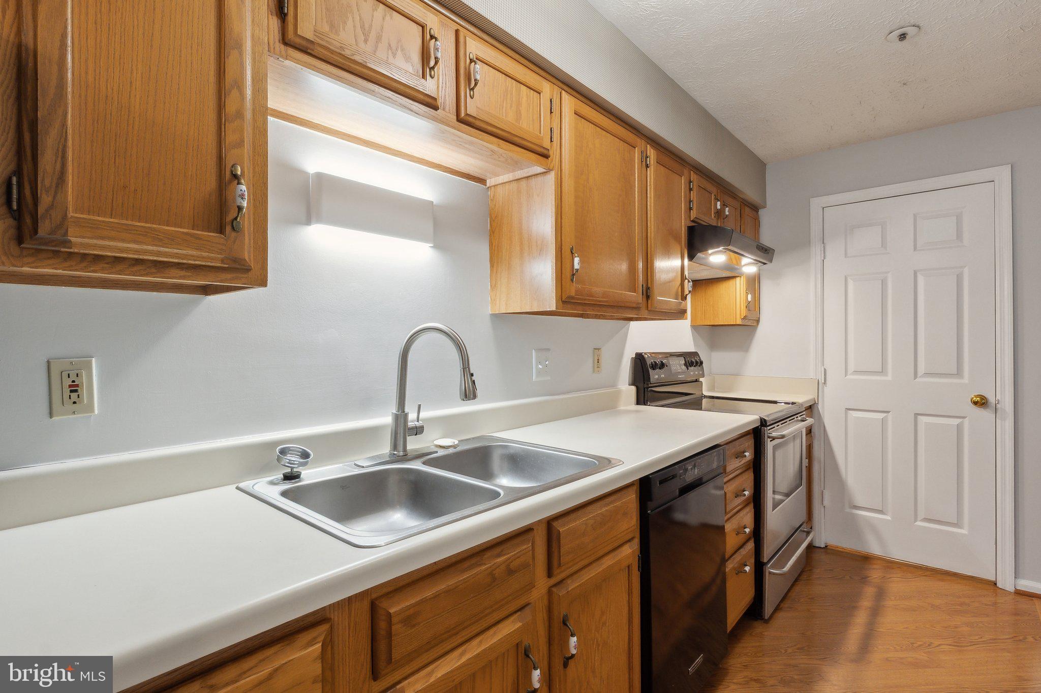 815 Deering Road, Unit 7H Pasadena, MD 21122 - Photo 6 of 24 a kitchen with a sink and cabinets